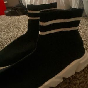 Black slip on high top shoes with white stripes